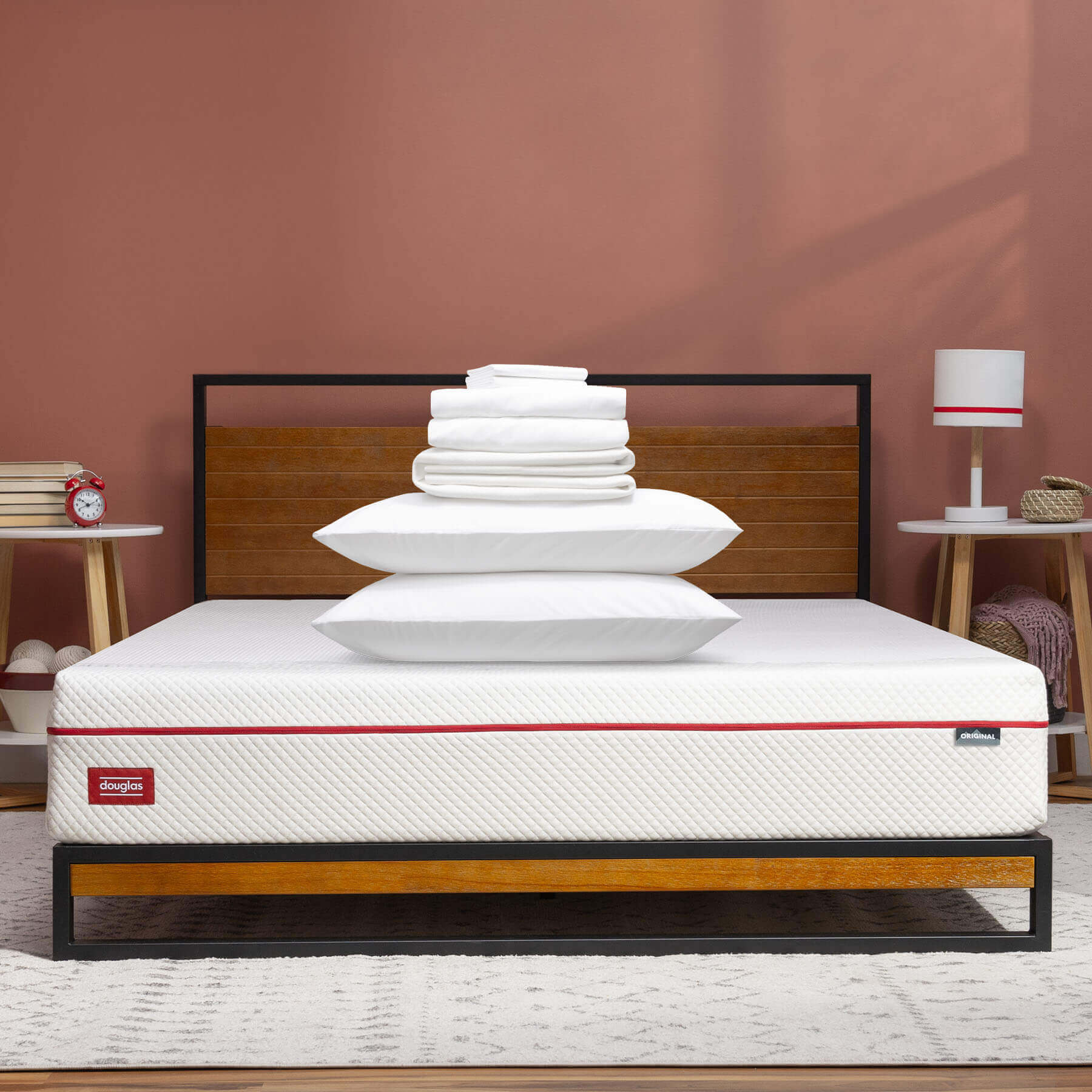 The contents of a Comfort Sleep Bundle stacked on top of a Douglas mattress