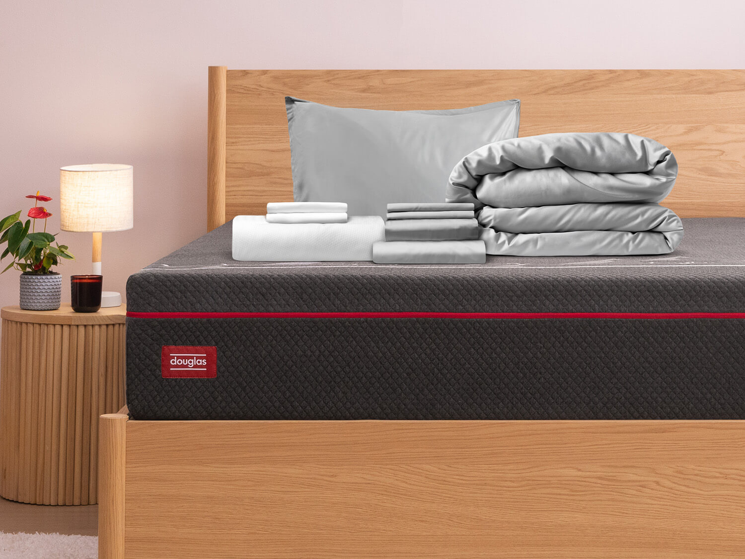 Premium Sleep Bundle items on top of a Douglas Hybrid mattress