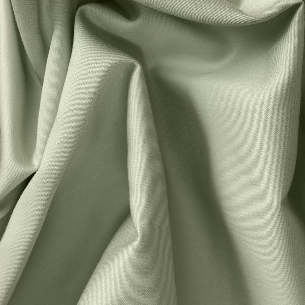 Closeup of the texture of sage green sheets