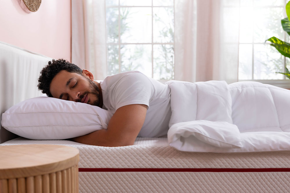 Man sleeping on his stomach, head resting on a Adjustable Memory Foam Pillow