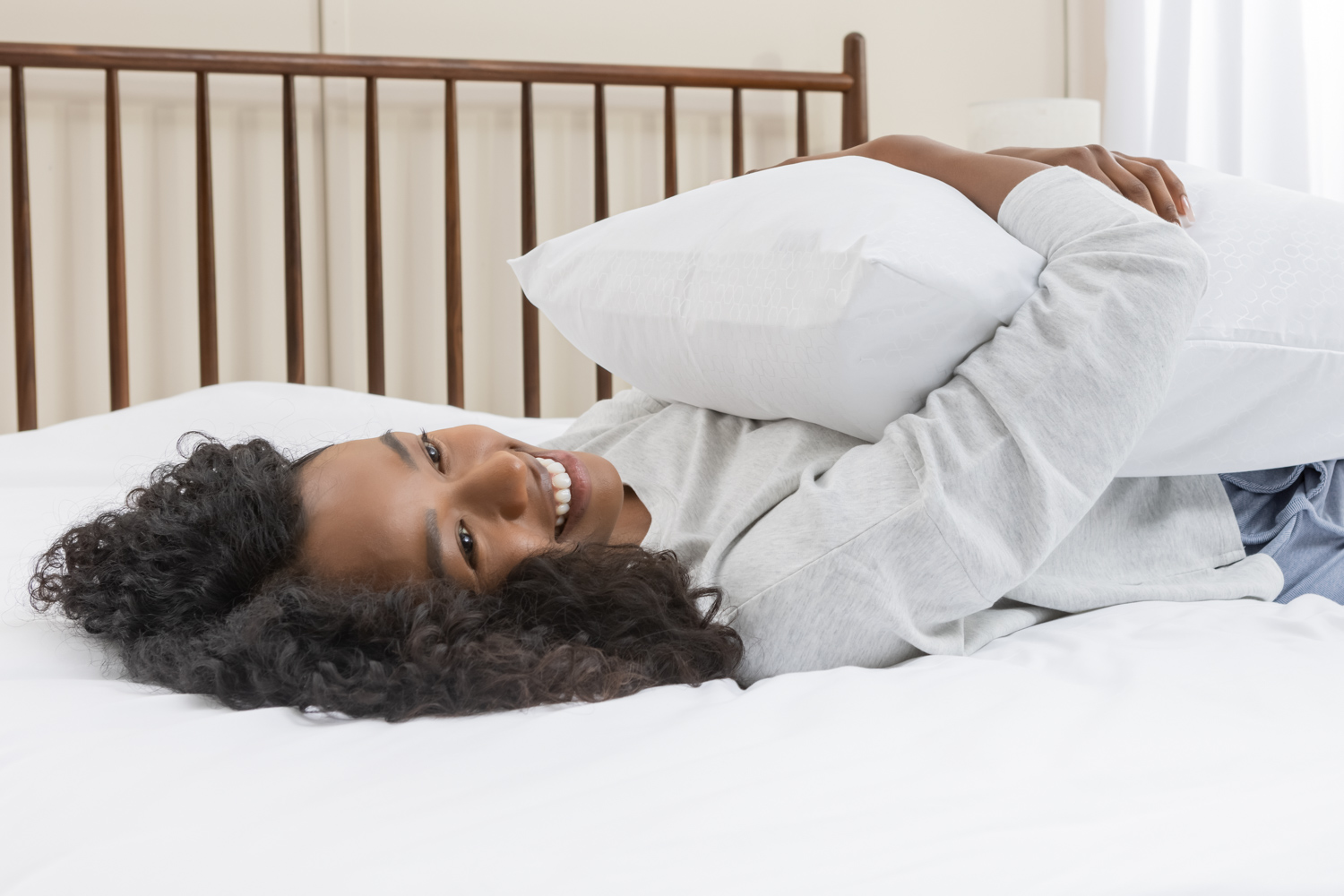 A person hugging a pillow that uses our pillow protector A person hugging a pillow that uses our pillow protector