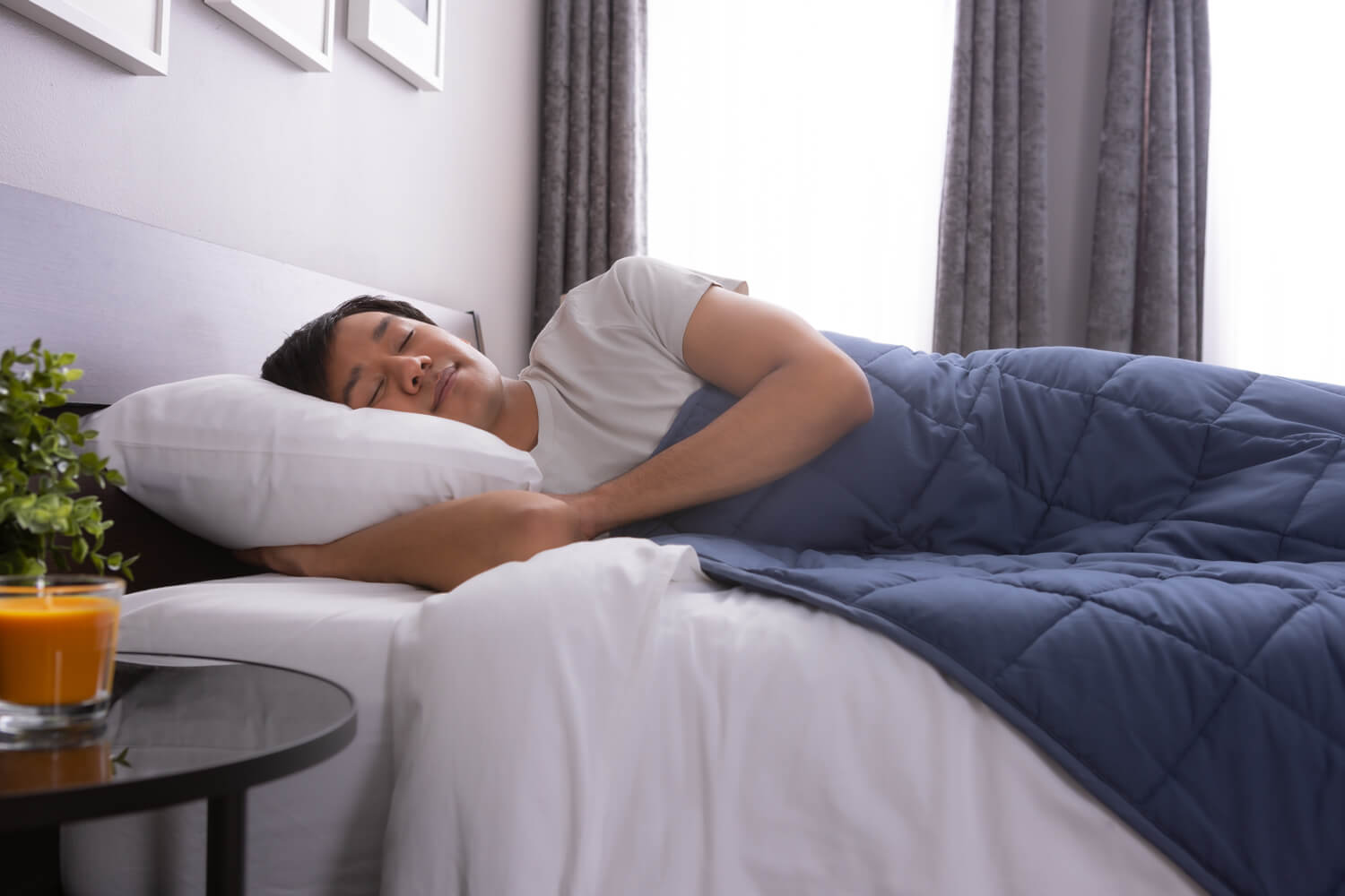 Perfect Pressure Man peacefully resting in bed, with Classic Weighted Blanket spread across his body