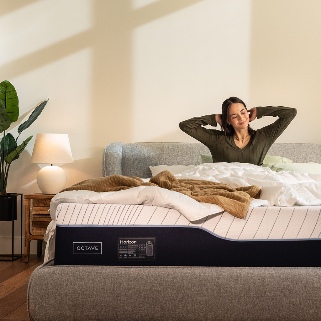 A woman waking up refreshed in an Octave Horizon mattress