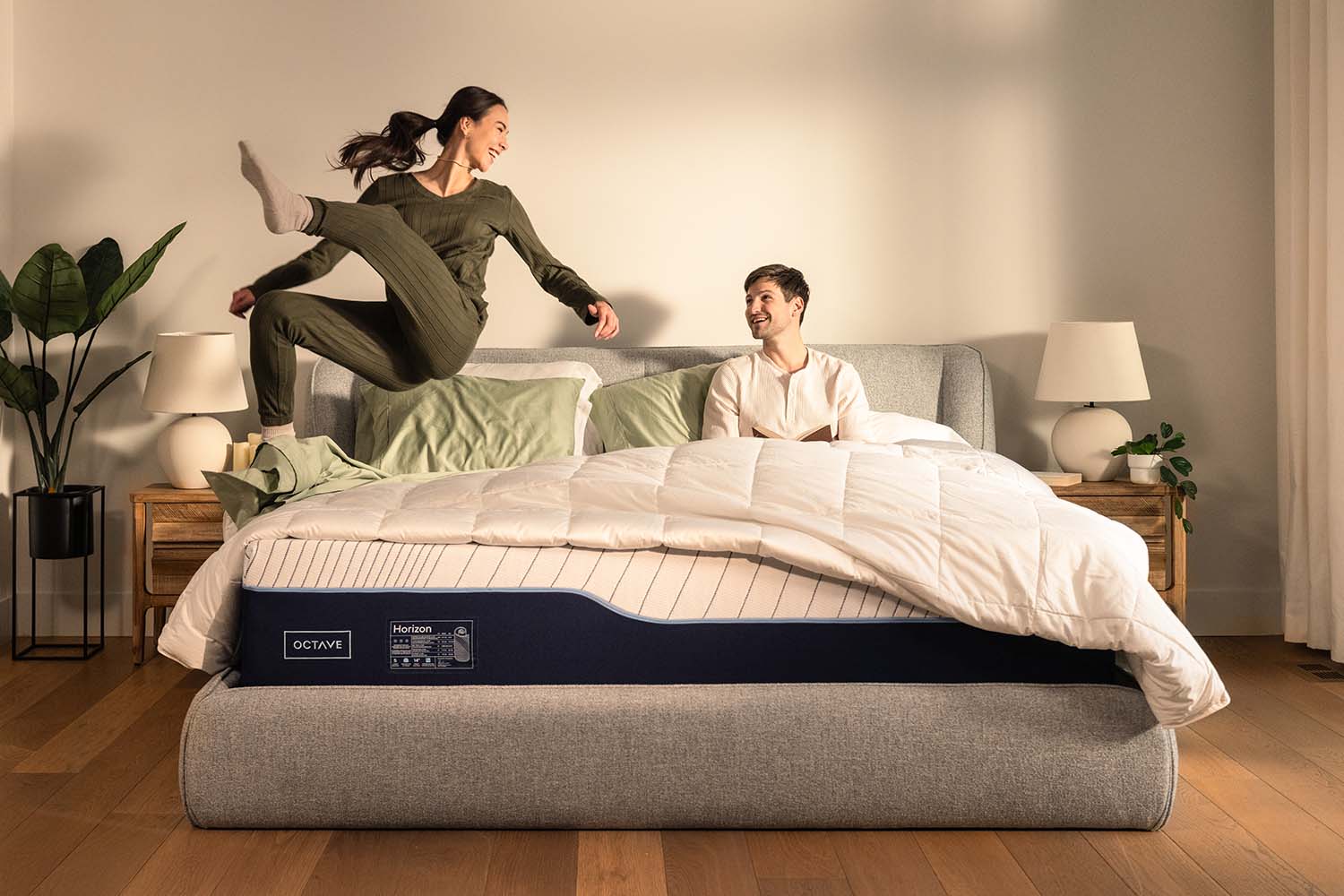 Woman jumping into bed of an Octave Horizon mattress.