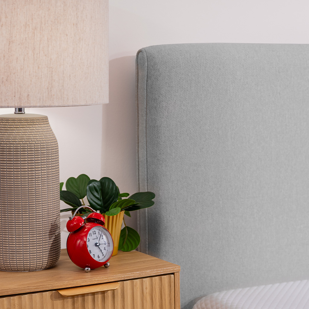 Bed frame's headboard sits flush against the wall