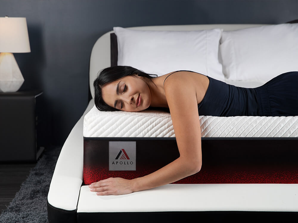 apollo-mattress-07 Woman laying with her eyes closed on the edge of the Apollo mattress