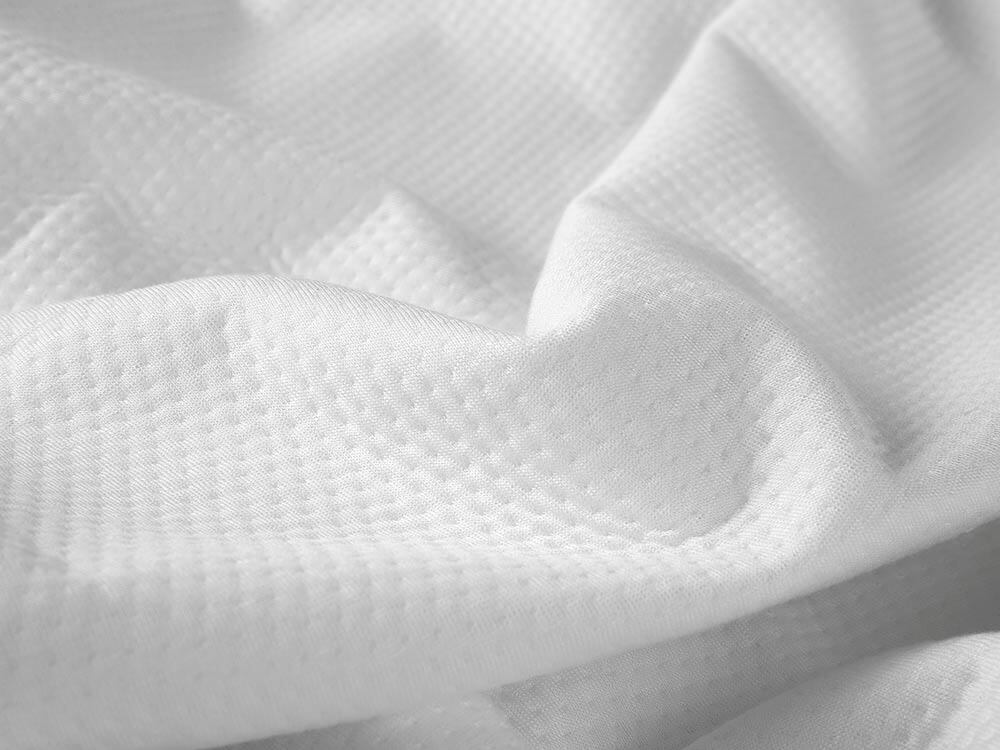 A close view of the mattress protector's fabric.