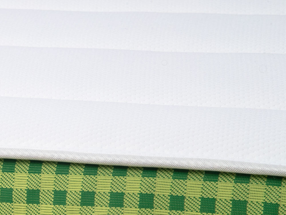 Brunswick Spring Mattress Euro-Top | GoodMorning.com Close-up of the white cover and green plaid ribbon along the Brunswick classic spring mattress