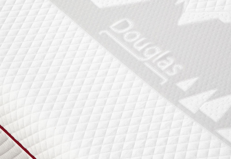 Douglas mountainscape logo on the white top cover of the Douglas mattress