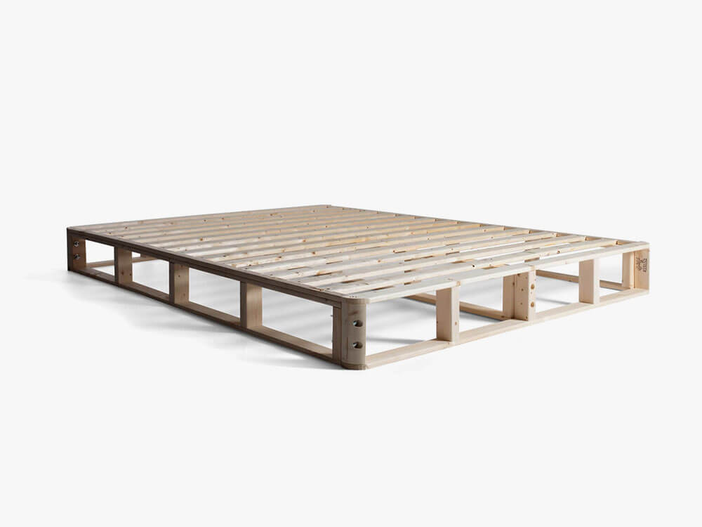 Image of the corner of the wood frame of a GoodMorning.com mattress foundation against a white background.